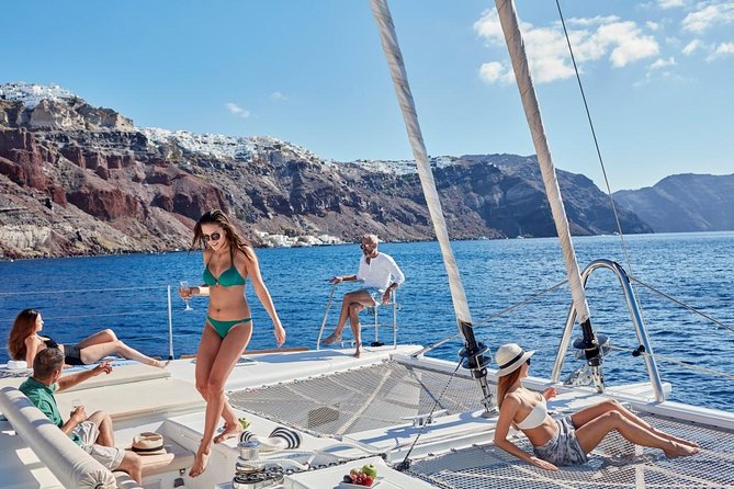 Santorini Sunset Luxury Sailing Catamaran Cruise With Bbq, Drinks, Transfer - Santorinis Beaches and Snorkeling