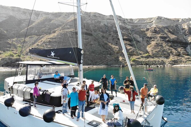 Half-Day Exclusive Catamaran Cruise in Santorini With Meal and Open Bar - On-Board Activities and Dining Experiences