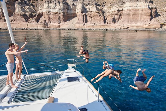 Santorini Gold Catamaran Cruise With Bbq, Drinks and Hotel Pickup - Visiting Colorful Beaches