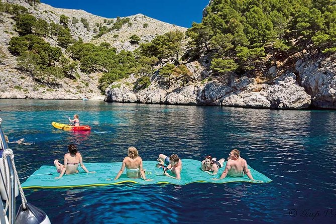 Catamaran Cruise From Port Dalcudia With Lunch and Swim Stop - Onboard Amenities and Inclusions