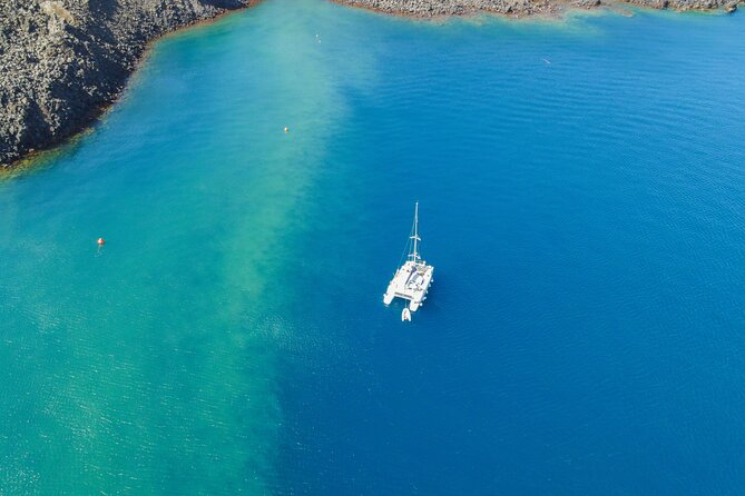 Full Day Santorini Catamaran Private Cruise With Meal and Transfer - Snorkeling Equipment and Private Transportation