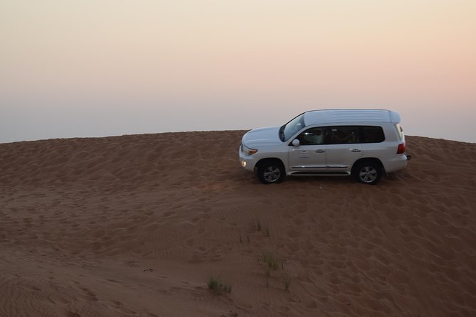 Dune Bashing With Quad Bike and Sand Boarding From Dubai - Sandboarding Excitement