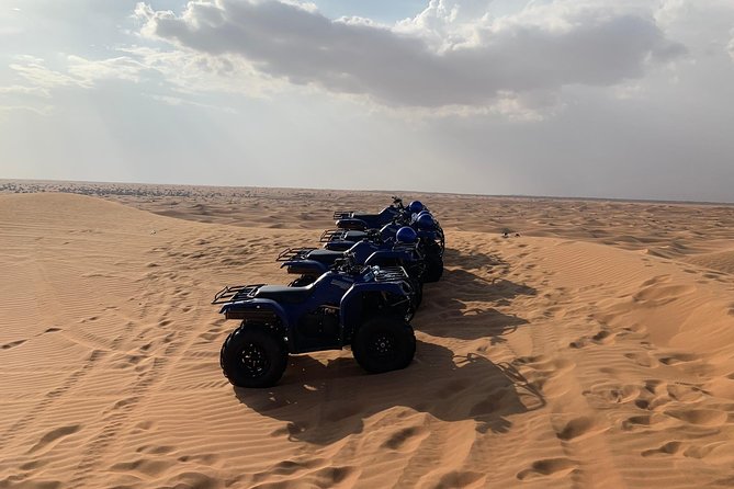 Dubai: Unique SUNSET Quad Bike Red Dunes Safari - Camel Ride Highlight