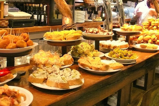 Boqueria & St Caterina Markets With Food & Tapas Small Group Tour - Enjoying Traditional Meat Dishes