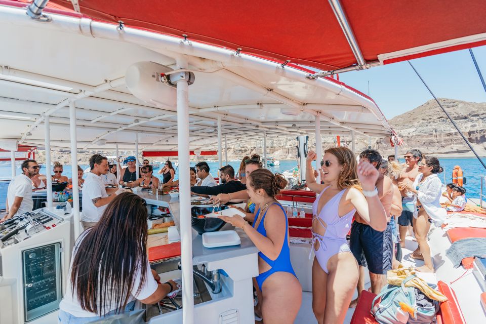 Santorini: Catamaran Tour With BBQ Dinner, Drinks, and Music - Onboard Amenities and Services