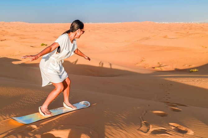 Red Dunes Desert Safari, Sand Board, Camel Ride With BBQ Dinner in Premium Camp - Exciting Sandboarding Opportunity