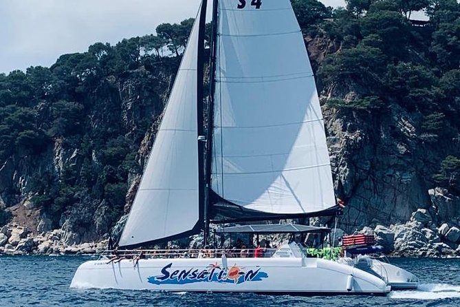 Sailing Along the Costa Brava in a Large Catamaran With a Buffet-Barbecue and Swimming Inlet. Drinks Are Included. - Music and Open-Air Ambiance