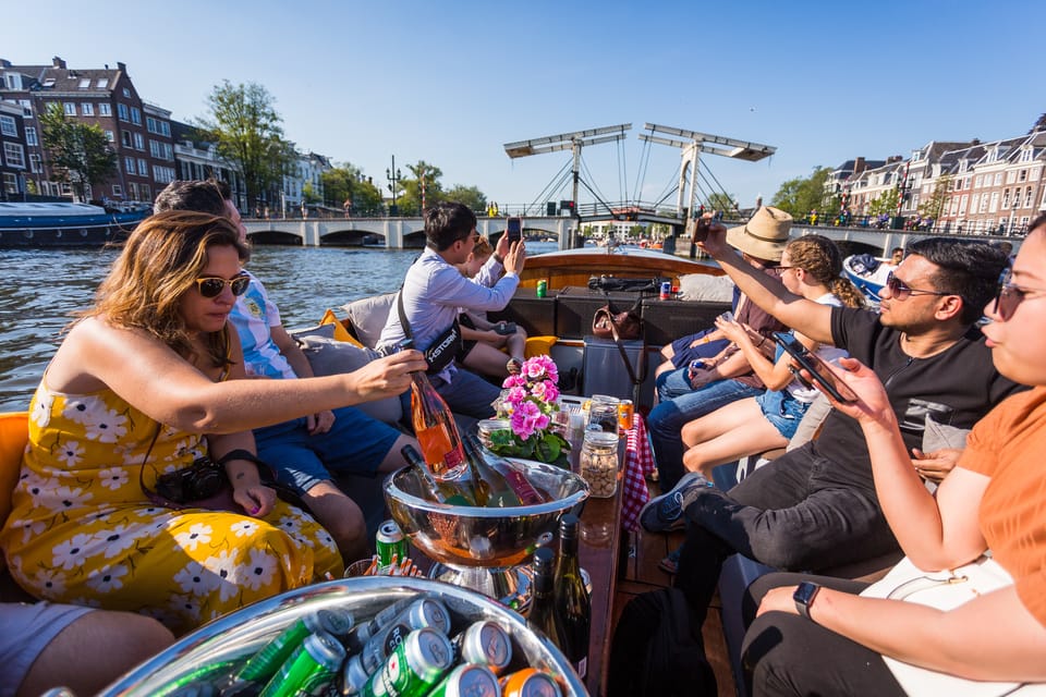 Amsterdam: 1.5-Hour Guided Canal Cruise With Drinks & Snacks - Itinerary and Starting Locations