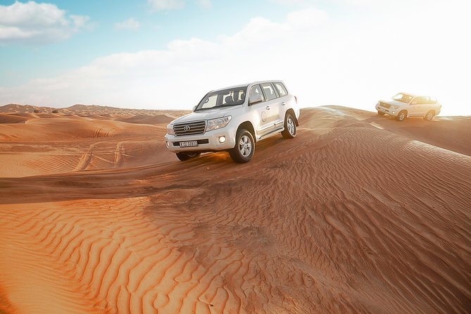 Desert Safari Dubai With Dune Bashing, Sandboarding, Camel Ride, 5 Shows, Dinner - Camel Riding Across the Dunes