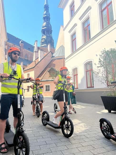 Riga Highlight Big wheel e-scooter Group or Private tour - Entering Riga’s Historic Old Town with E-Scooters